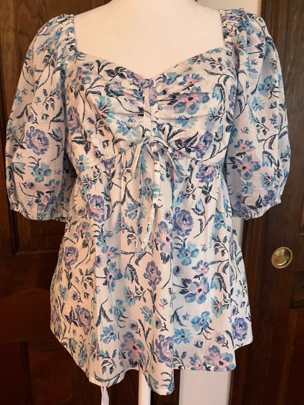 Puff sleeve, princess neck shirt with smocked back. Blue flowers- size m
